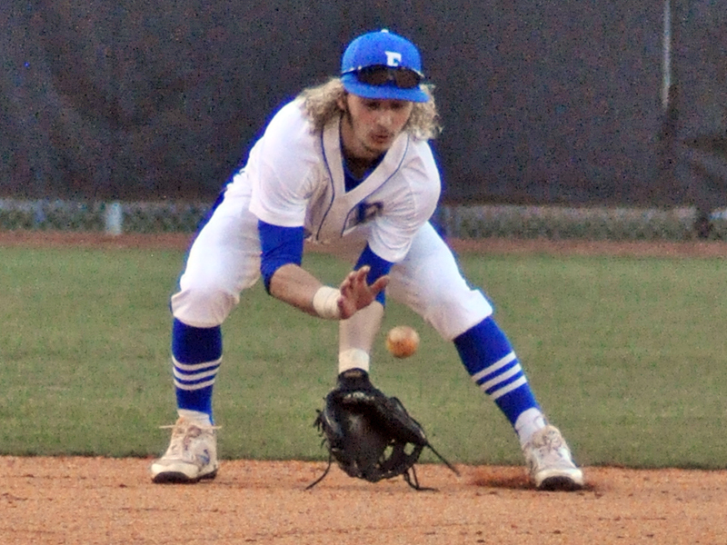 Wyatt Rogers scoops up a ground ball during the Rebels’ game against Union County Wednesday, February 24.