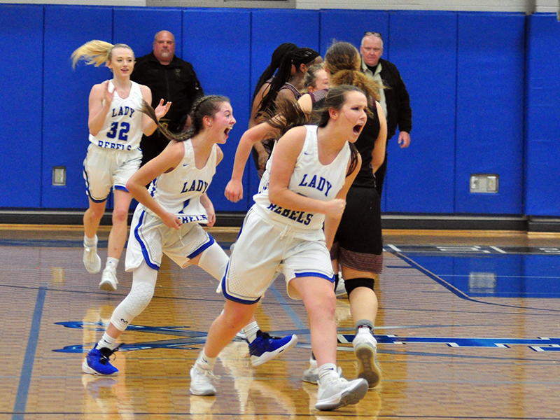 Lady Rebels Mackenzie Johnson (32), Courtney Davis (1) and Natalie Thomas (30) celebrate as the clock hits double zeros in their Sweet Sixteen win against Heard County Friday, February 26.