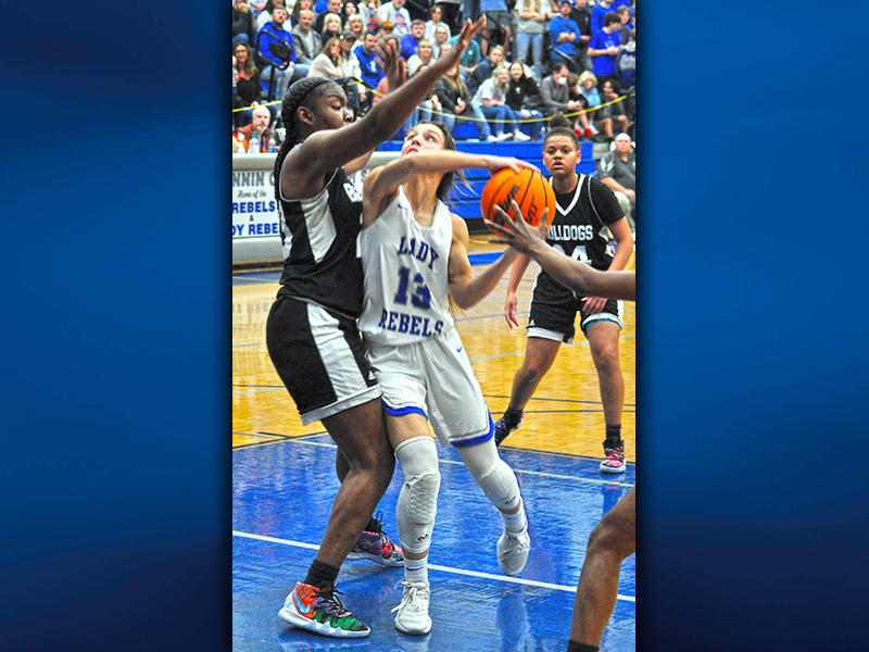 The Lady Rebels’ Becca Ledford fights for two of her 15 points against Butler’s Lady Bulldogs Saturday night. The Final Four game in the chase for the state championship was played in front of a packed house in the Fannin County High School gym.