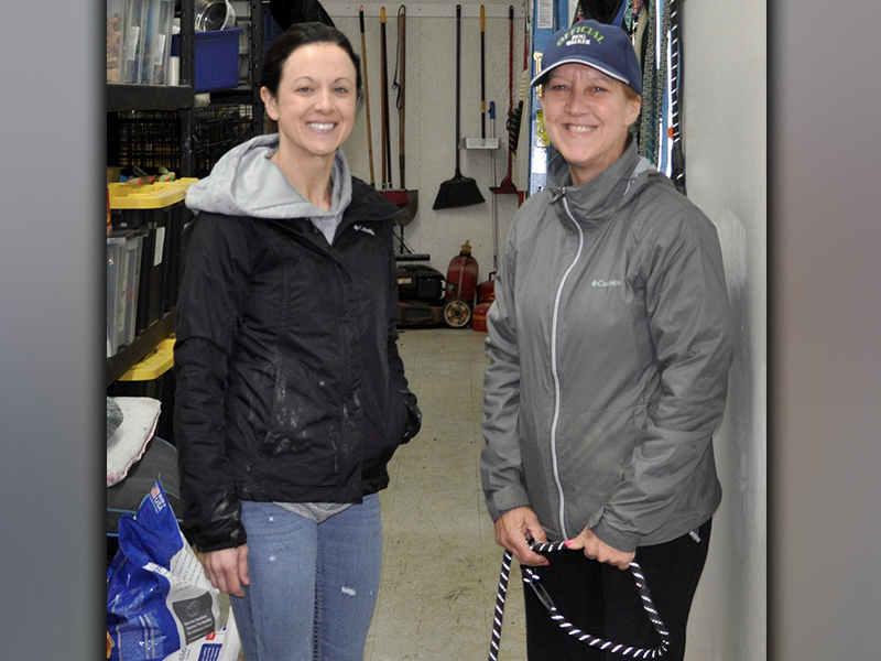 Fannin County Animal Control volunteers Jaime Pittman, left, and Donna Turek braved the cold and rain Friday morning, February 26, to walk and play with the dogs at the facility.