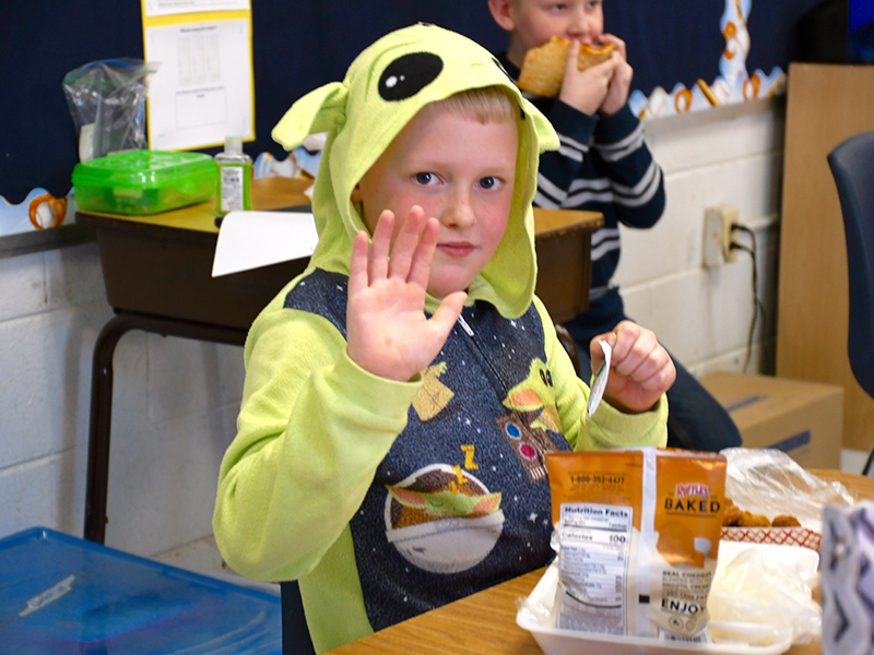 East Fannin Elementary School student Ty Cochran waves in his Baby Yoda pajamas during the school’s Read Across America Pajama Day.