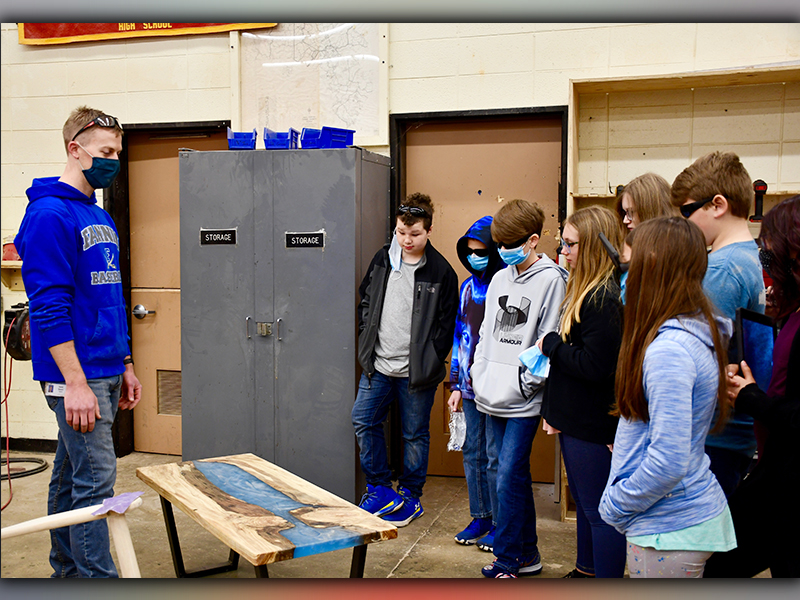 Fannin County High School construction teacher Daniel Stewart shows off a resin table that one of his students completed to fifth grade students from East Fannin Elementary School to demonstrate the types of projects they could work on if they participate in CTAE in the future.