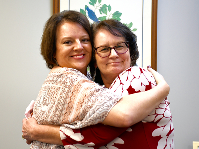 RIGHT: Fannin County Chief Tax Appraiser Dawn Cochran, left, celebrated her friend and co-worker Chief Land Development Officer Marie Woody’s 40 years of service to the county with a big hug.