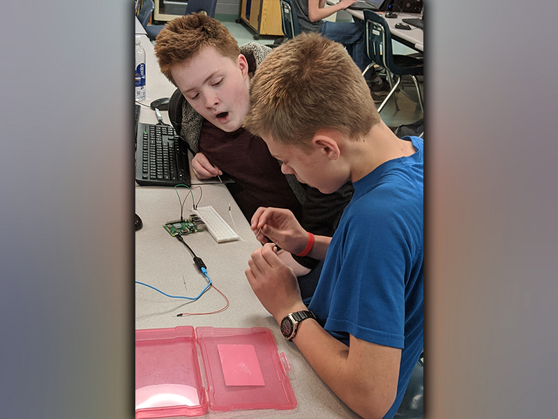 Fannin County Middle School students Steven McBee and Steven Dickey programming LED lights with a Raspberry Pi, which is a small computer used to learn programming.