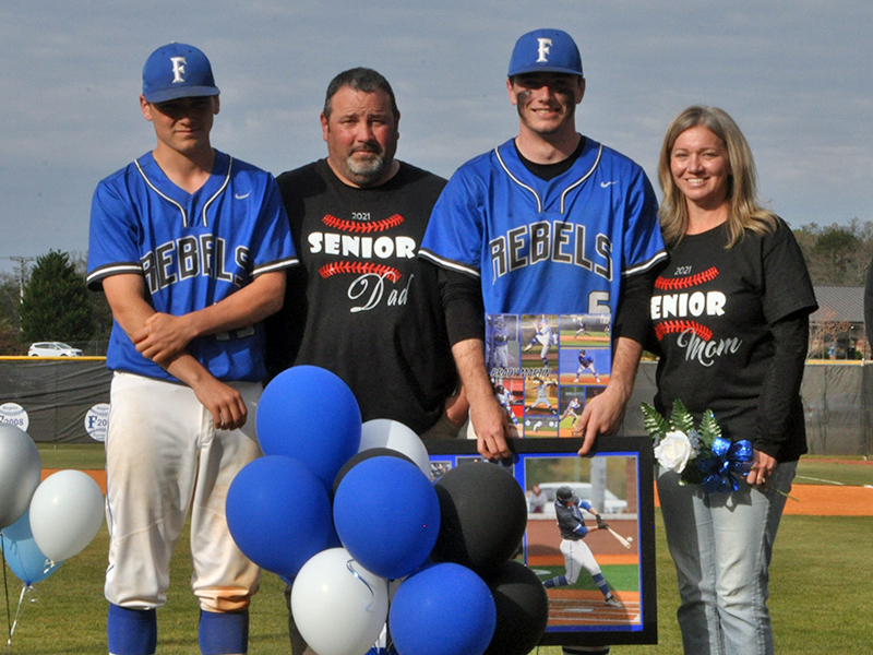 Brady Martin was one of seven Fannin County seniors honored in between games at the Rebels' double header against Chattooga Friday, April 23. Shown are from left, Connor Martin, brother; Mitchell Martin, father; Martin; and Teresa Martin, mother.