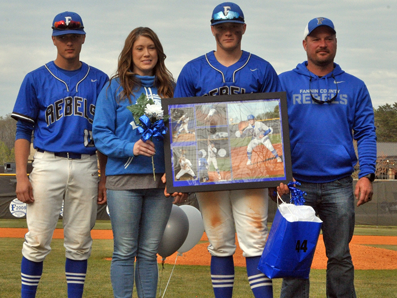 Bradley Holloway was one of seven Fannin County seniors honored in between games at the Rebels double header against Chattooga Friday, April 23. Shown are from left, Bryson Holloway, brother; Crystal Holloway, mother; Bradley Holloway, senior; and Joseph Holloway, father.