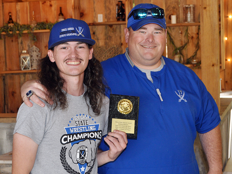 Kainan Henson was awarded the Three-Time Threat Award for placing in the state tournament three years. Henson placed fourth in the 2019 AAA State Tournament, sixth in the 2020 AAA State Tournament, and third in the 2021 AA State Tournament. Henson is shown with Head Coach Chuck Patterson