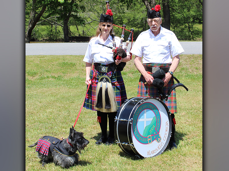 Appalachian St. Andrew's Pipes & Drums of Blairsville, Georgia members Dorothy and Sid Bugg and their scottie, Archie, Troop enjoy Troop 32's Highland Games Saturday, May 1 after leading the procession of Boy Scouts.