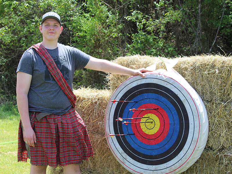 Troop 32 Boy Scout Ethan Jolly shows off his bulls-eye shot after he tackled the archery portion of Troop 32's Highland Games Saturday, May 1.