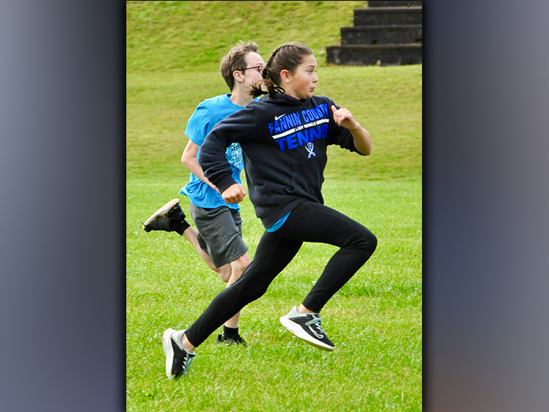 Sadie Patton pushes past Will O’Neal and into first place during a race against peers amidst West Fannin Elementary School’s field day.