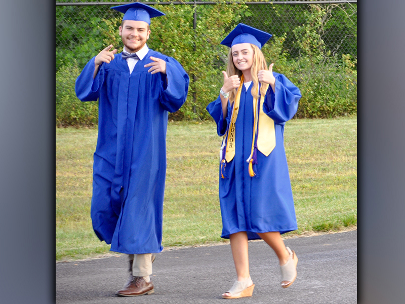 Fannin County High School graduates Maximus Mathis and Lainey Panter make their walk down to the football field before beginning the graduation ceremony Friday, May 21.