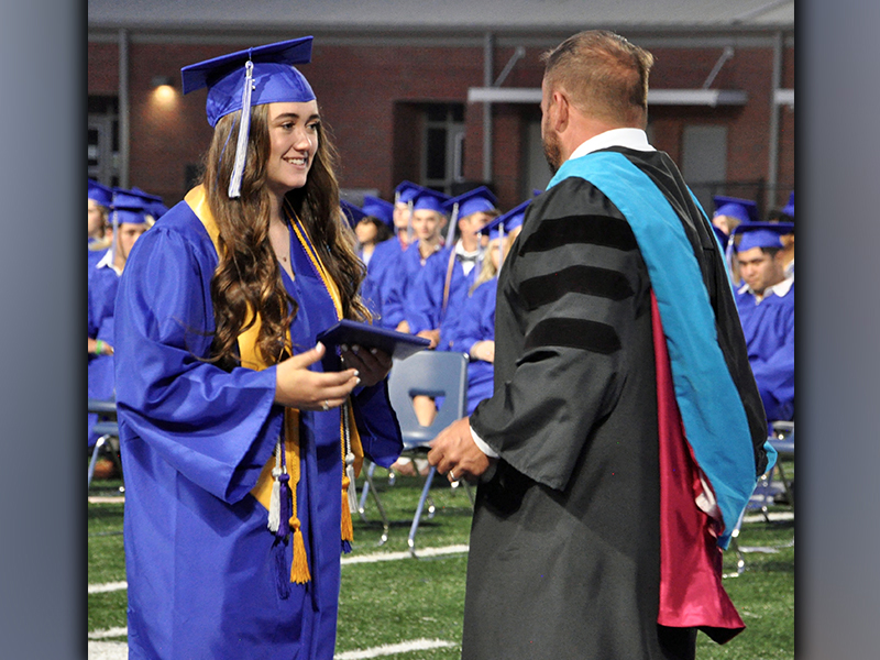 Catherine Ballew accepts her diploma from Fannin County High School 2021-22 Principal Dr. Scott Ramsey during graduation Friday, May 21.