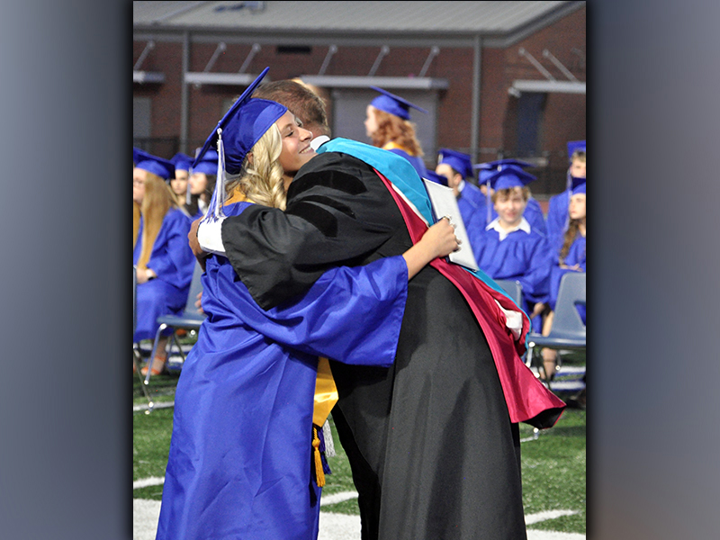 Teagan Cioffi embraces Fannin County High School 2021-22 Principal Dr. Scott Ramsey after being handed her diploma during graduation Friday, May 21.