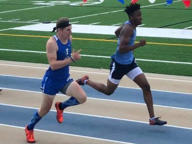 Thomas Mercer, left, battles with Aaron McFadden in the 300 Meter Hurdles Finals during the Track and Field Championships Saturday, May 15.