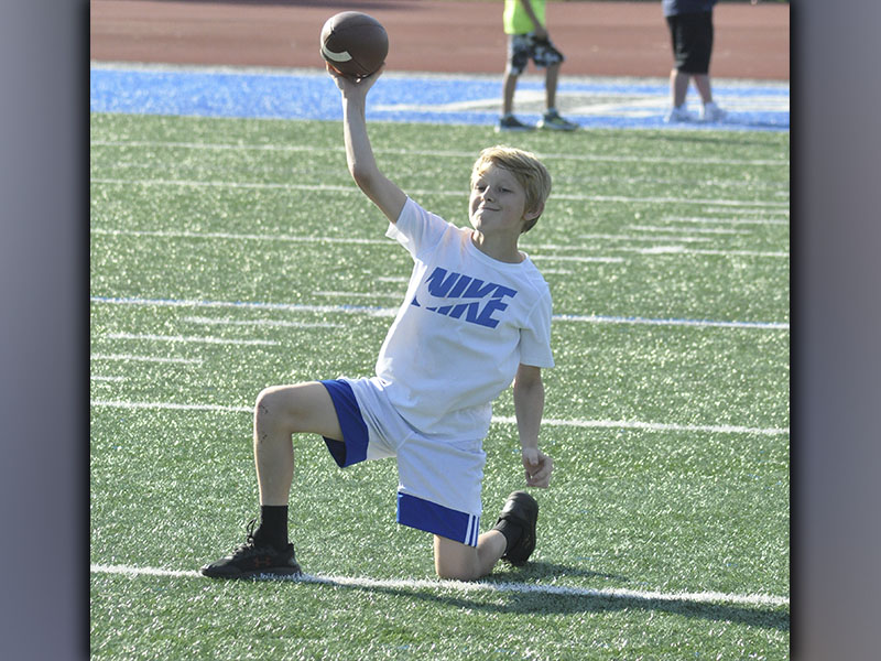 Bentlee Jackson works with the quarterback group on his throwing technique during the Fannin County High School football youth camp Wednesday, June 16.