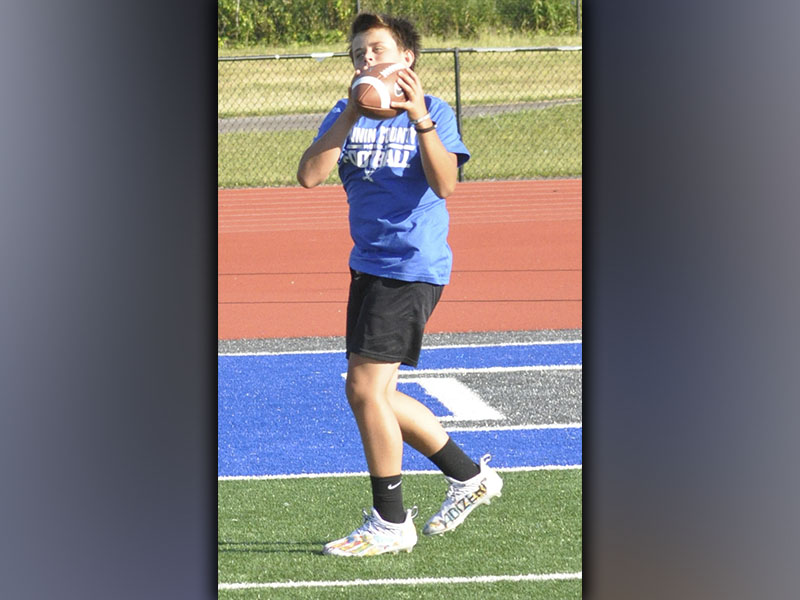 Reid Holloway works on his focus while he catches a pass during football camp hosted by the Fannin County High School football staff Wednesday, June 16.