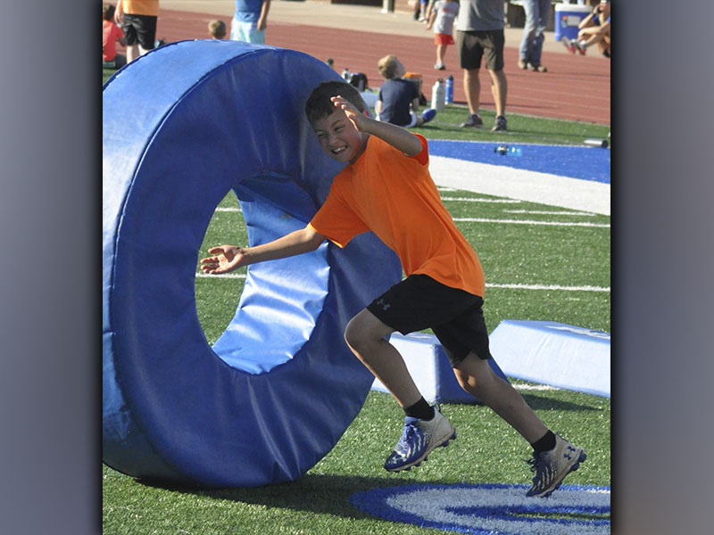 Shawn Simmonds practices his tackling on a doughnut during the football camp at the Fannin County High School football field Wednesday, June 16.