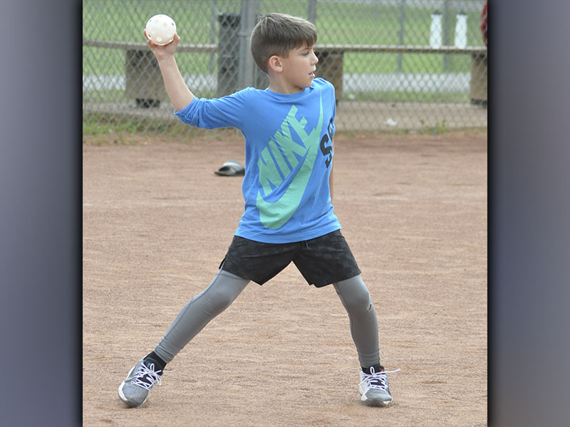 Kyle Allen tries to throw a runner out at the rec department’s Summer Camp Wednesday, June 9.