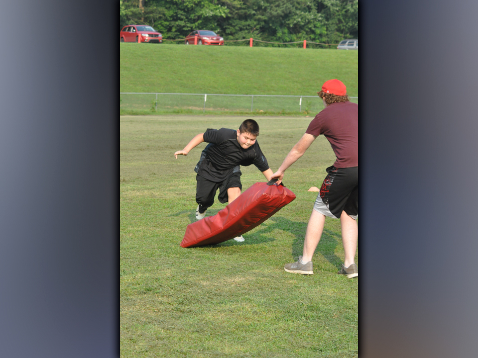 Trenton Davis works on his tackling technique during the youth football camp hosted by the Copper Basin High School football team Thursday, July 22.