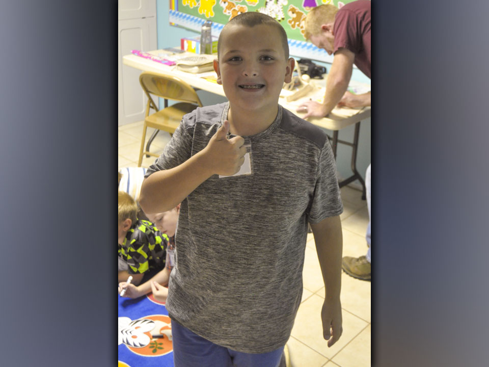 Izaiah Bradburn takes time out of coloring to smile for a photo during McCaysville Gospel Tabernacle’s Vacation Bible School Tuesday, July 13.