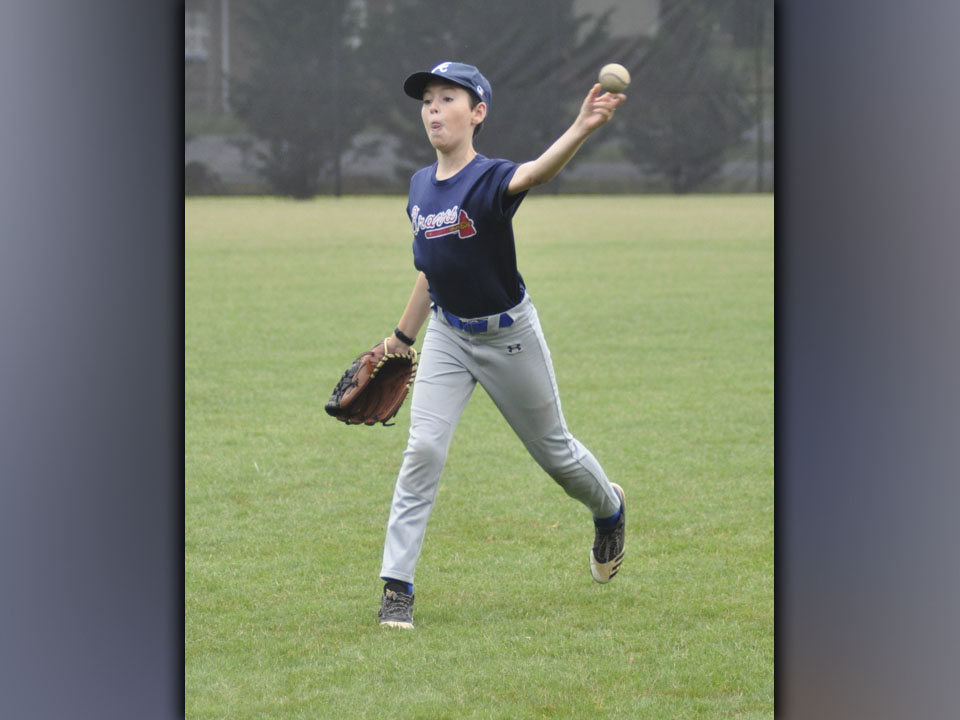 Henry Schueneman winds up for a throw. He was one of the many participants in a Fannin County High School baseball camp.