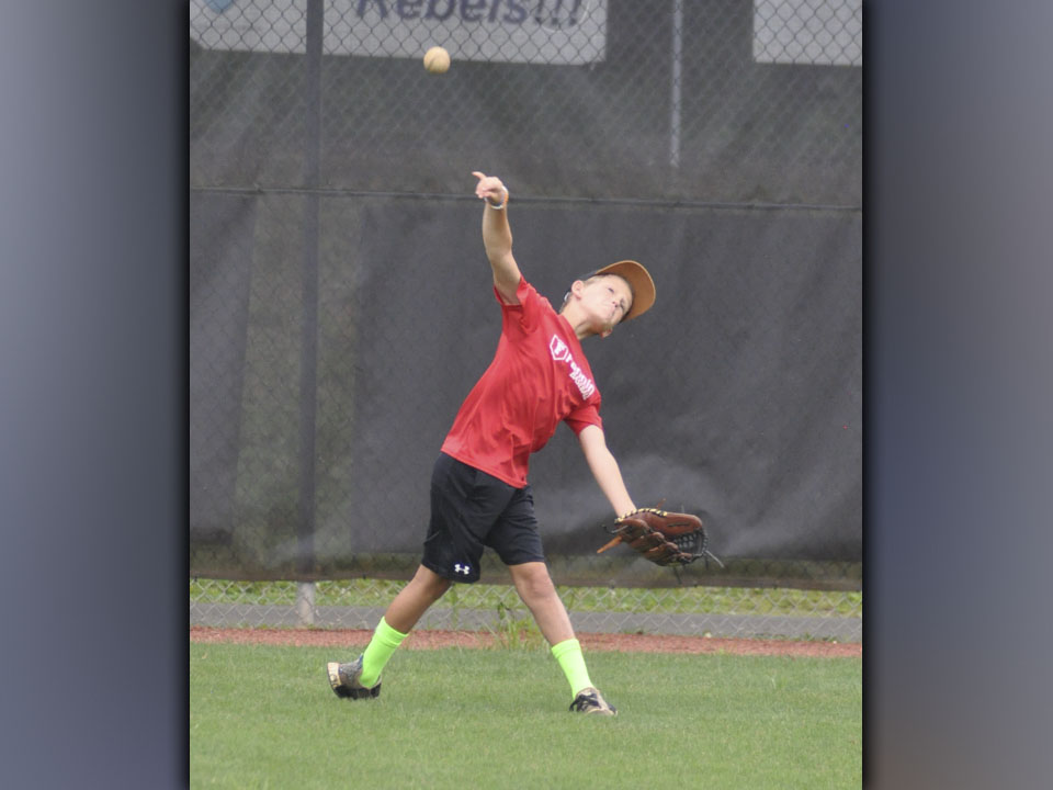 Parker Borns gets the ball to his throwing partner during the Pitchers and Catchers Camp Wednesday, July 7.