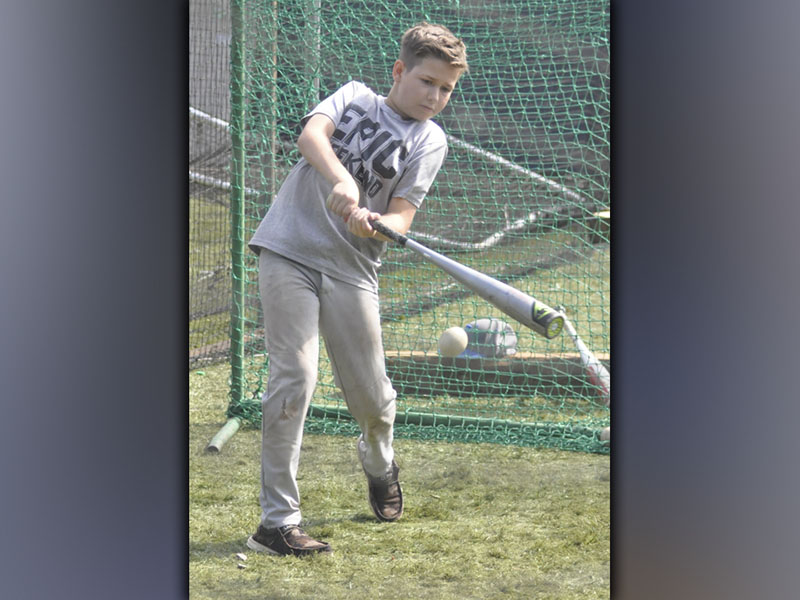 Liam Highley dings a ball during the hitting camp hosted by the Fannin County High School baseball coaches and players Wednesday, July 14.