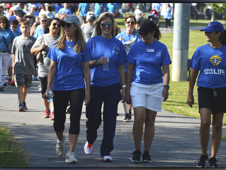Individuals participate during HER HOPE Pregnancy Center’s Walk for Life fundraiser Saturday, June 26.