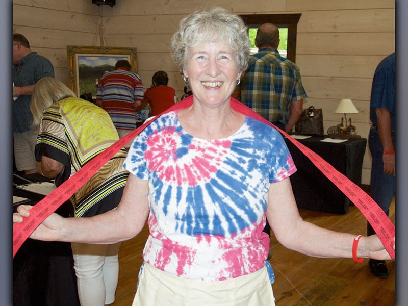 Suzanne Stedman walks around during Paws for Celebration selling 50/50 raffle tickets Saturday, July 17.
