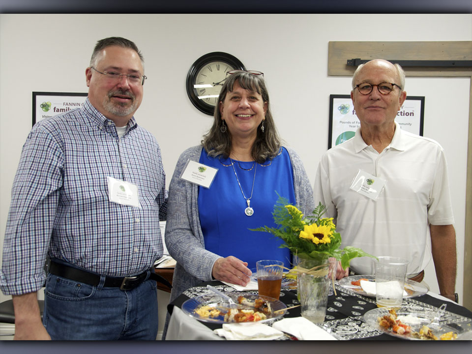 Fannin County Family Connection Board of Directors members Michael Kilpatrick, Anna Speessen and Gordon Riddoch, from left, smile for a photo during Fannin County Chamber of Commerce’s Business After Hours.