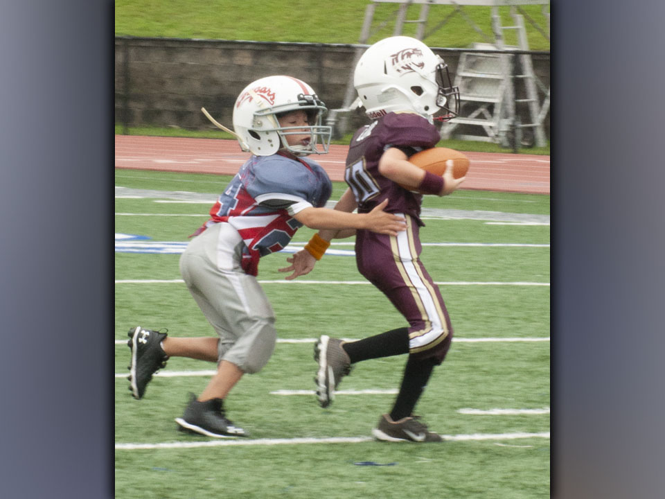 Preston Finney (24) brings down a ball carrier during the Cougars game at Fannin’s jamboree Saturday, August 21. 