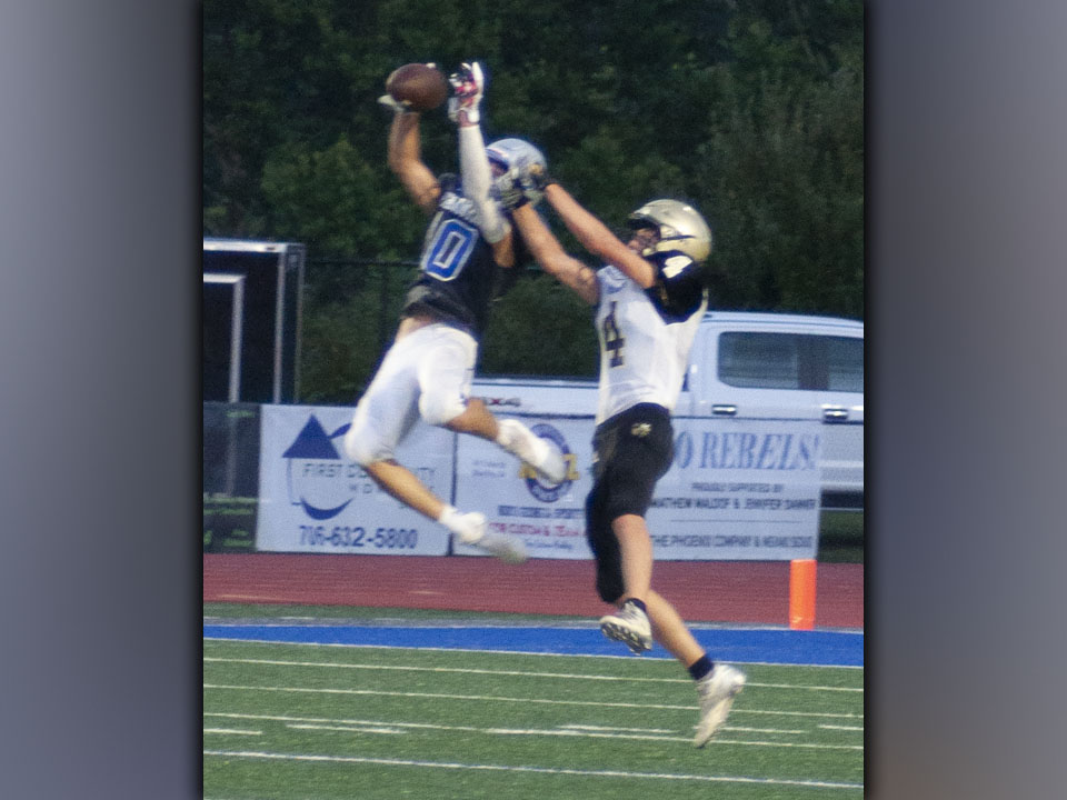 Carter Mann (10) shows his hops by snagging a pass during the Rebels scrimmage with the Hayesville Yellow Jackets Friday, August 13.