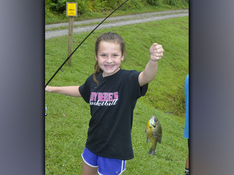 Lynnex Patterson smiles as she shows off her nice Bluegill she caught at Fannin County Recreation Department’s fishing camp Wednesday, July 28. Patterson caught over 10 fish that day.