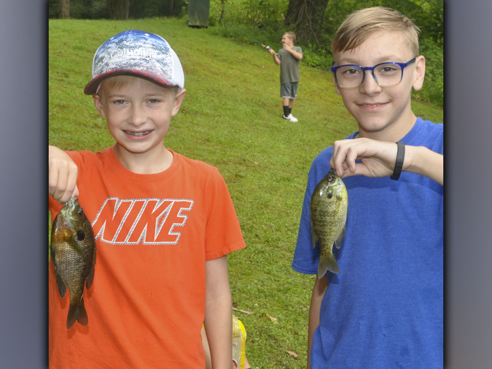 Jacob Curtis, left, and Jonathan Jones caught two Bluegill at the same time during the Fannin County Recreation Department’s fishing camp Wednesday, July 28.
