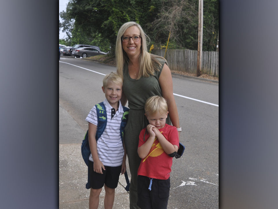 Stopping to pose for a picture on the first day of school at Blue Ridge Elementary School Friday, July 30, are, from left, second grader Tucker Mathews, his mother Beth Mathews, and  younger brother Parker Mathews.