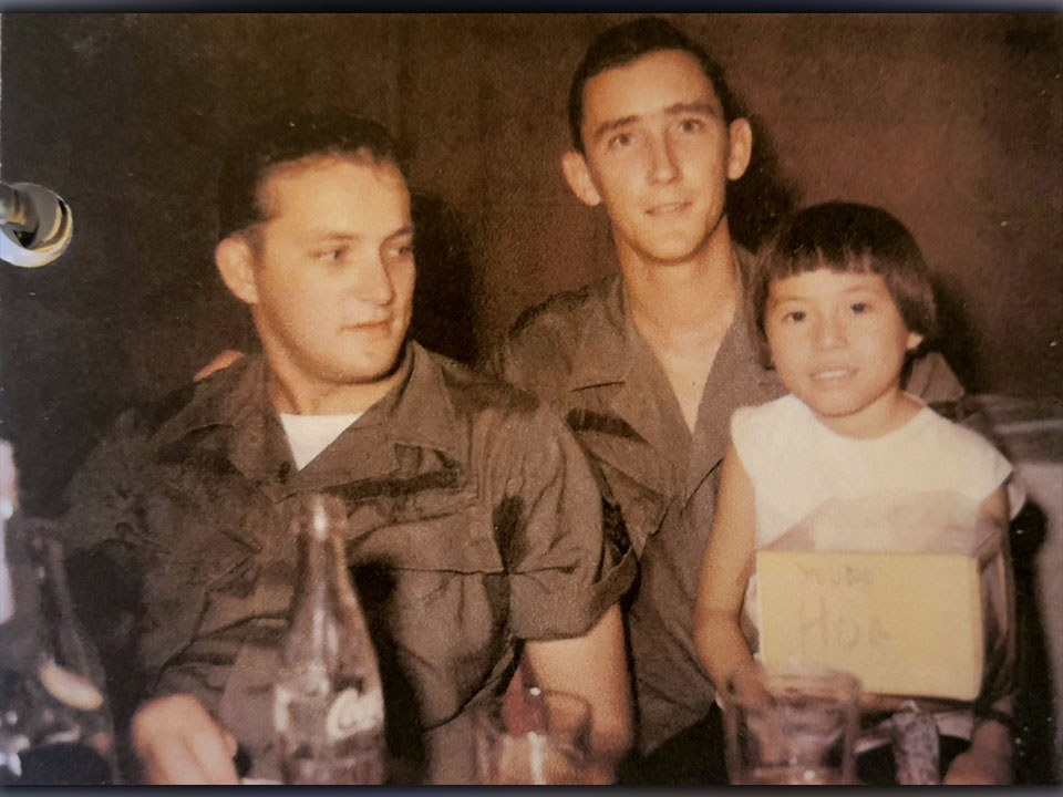 In Saigon, U.S. Air Force veteran Richard Crosley, left, is shown with a friend and a young, native girl named Hoa who he and his friends would give candy and treats to every time they knew they’d cross paths.