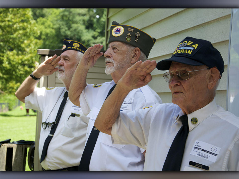 Members of the North Georgia Honor Guard, from left, Steve Strickland, Nick Wimberley and Ed Judge salute the American Flag just before reciting the Pledge of Allegiance during a Flag Etiquette class at Blue Ridge Elementary School Friday, August 27.