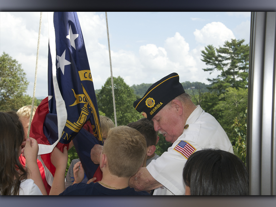 North Georgia Honor Guard member Gerald “Chief Mac” McMillen helps Blue Ridge Elementary School fifth grade students raise the American Flag.