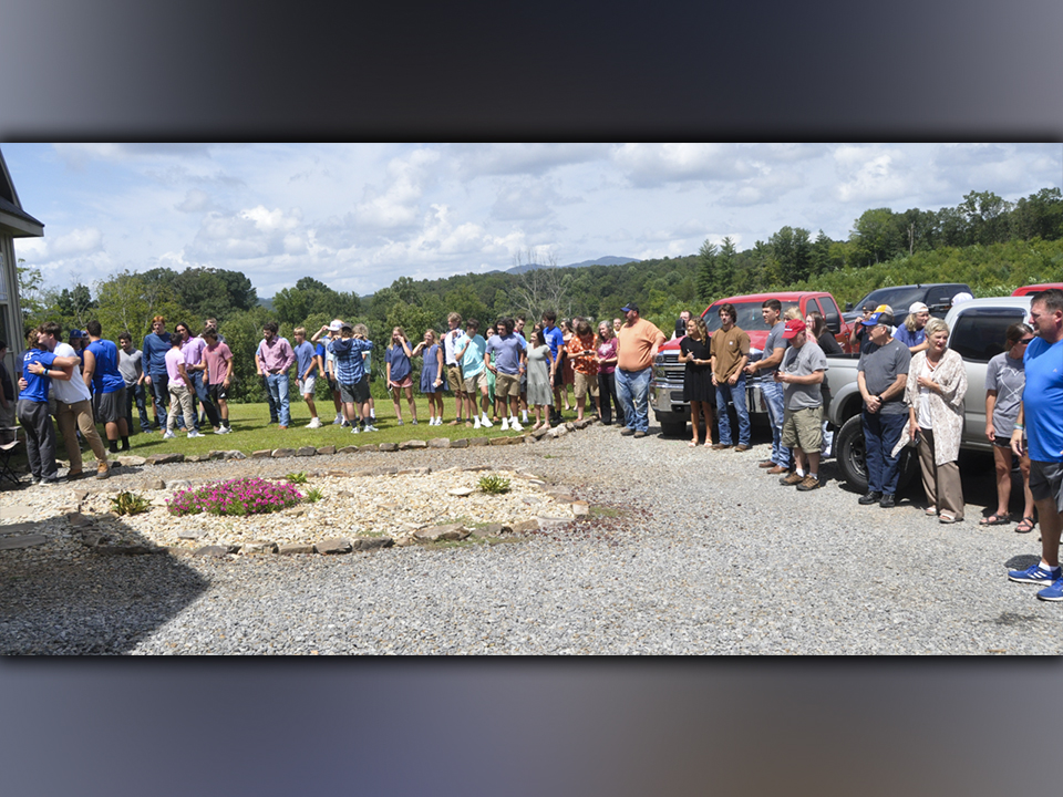 Family, friends and classmates gather outside the Davis’ home Sunday, August 29, for a distanced prayer meeting for Fannin County High School student and athlete Jackson Davis.