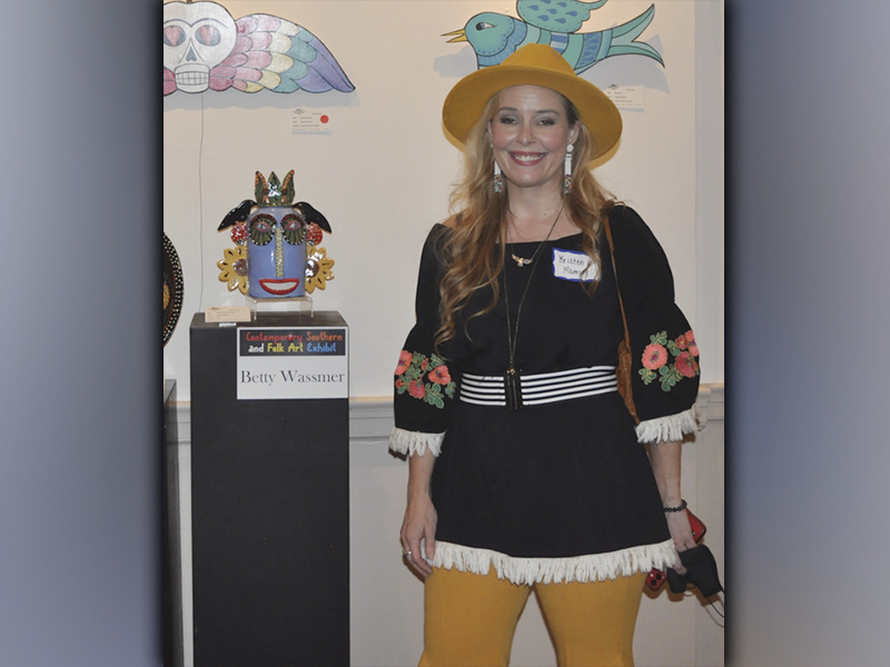 The Blue Ridge Mountains Arts Association held their opening reception for the Contemporary Southern Folk Art exhibit Saturday, September 4. Artist Kristen Ramsey presented her pieces  that are shown hanging on the wall behind her, which she cuts and carves designs out of plywood and paints with enamel. 