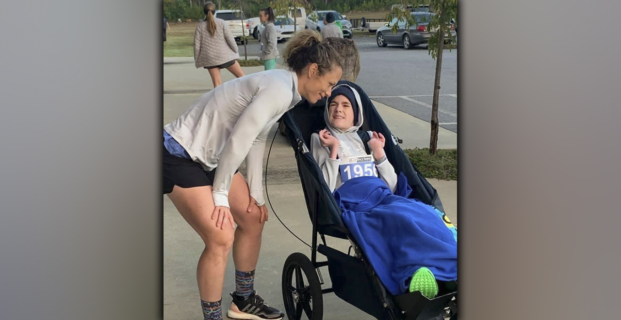 Brady Smith and his mother, Ashley Herendon, are all smiles after running in a community race.