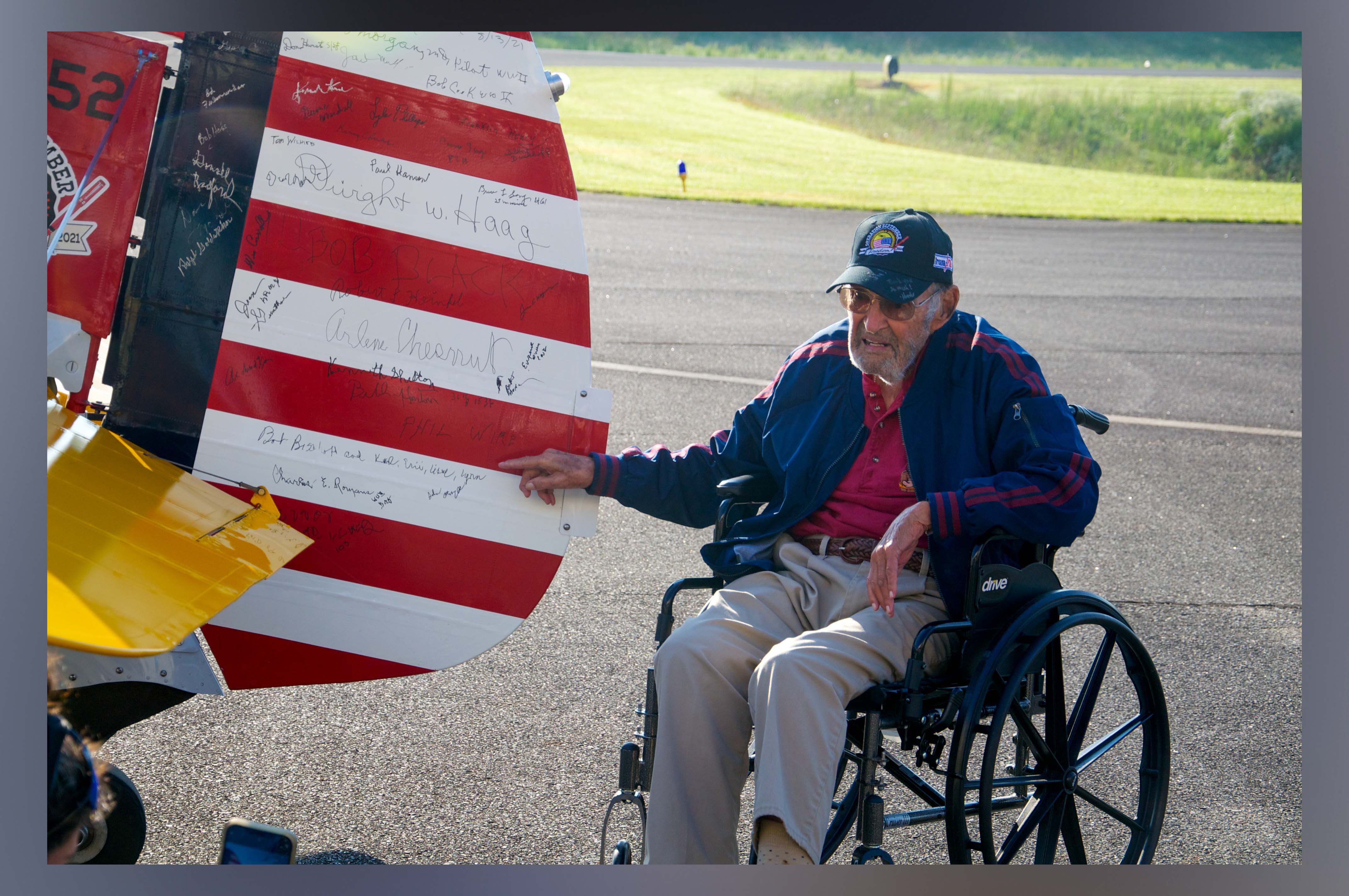 World War II Navy veteran John Ottwell points to his signature on the restored World War II biplane following his flight Tuesday, September 14.