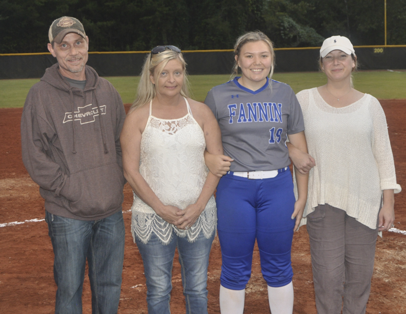 Lady Rebel softball players honored during the last home game of the season Tuesday, October 5. Shown with Davis are, from left, Henry Hall, stepfather; Mitzi Hall, mother; senior Kharcee Hughes and Crystal Campbell, stepmother.