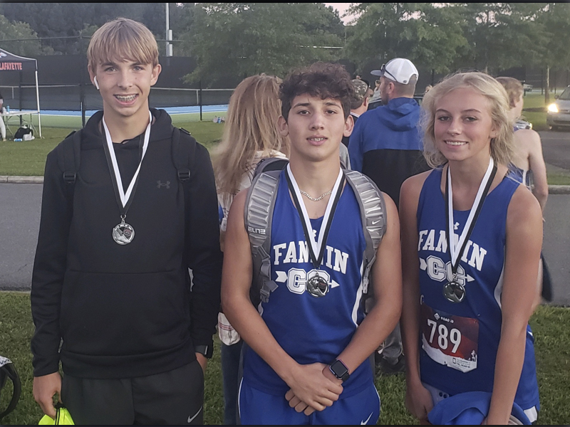 The Fannin County High School cross country team competed in the Wildwood Run at Edwards Park in Dalton, Georgia, Thursday, September 23. Medal winners from the meet include, from left, Gavin Davis, Zechariah Prater and Carlee Holloway.