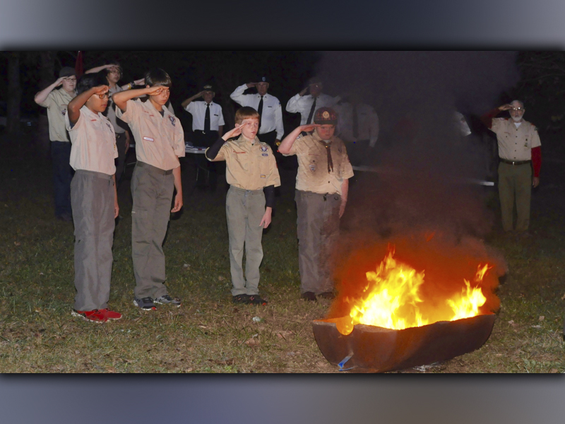 Boy Scout Troop 32 from Epworth held a Flag Retirement ceremony at Ron Henry Horseshoe Bend Park Tuesday, October 19. After placing the blue field in the fire, Boy Scout Troops, from left, Gandy Vincente, Austin Prieto, Clay Dillard and Patrick Thomas of Pack 432 salute as TAPS is played laying the retired flag to rest. 