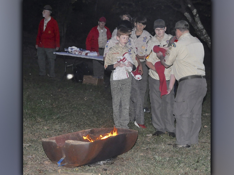 Boy Scouts from Troop 32 from Epworth prepare to place the 13 stripes in the fire that were removed from a U.S. flag they retired during a Flag Retirement Ceremony at Ron Henry Horseshoe Bend Park Tuesday, October 19. 