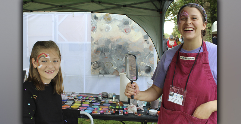 Addy Harvey shows off her face painting by Grace Johnson of Grace’s Painted Faces, Saturday morning at the fall Arts in the Park, October 9.