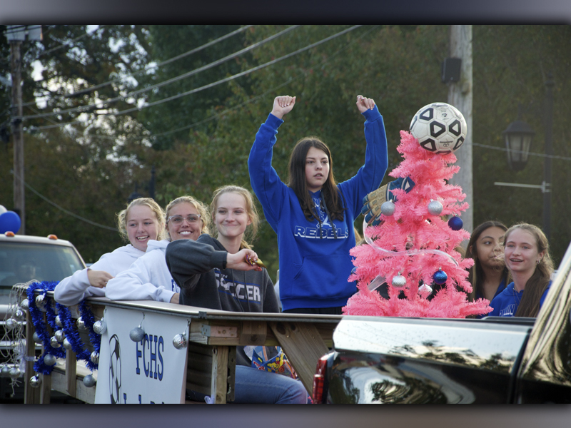 The Fannin County Lady Rebels soccer team hype up the crowd as they make their way along East Main Street in Blue Ridge for a Homecoming Parade Thursday, October 21. On the float are, from left, Annabel Lillard, Kinsley Sullivan, Abby McFarland, Alex Foster, Isobel Espinoza, Karmah Eaton, and, behind the tree, Ashley Campuzano.