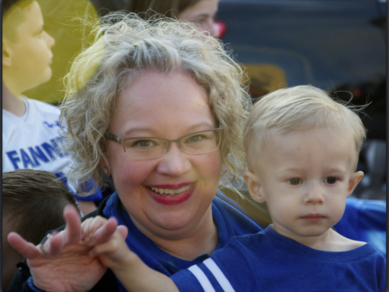 East Fannin Elementary School Assistant Principal Andrea Crump holds grandson Riley Davis while they show their Rebel pride during a Homecoming Parade Thursday, October 21.