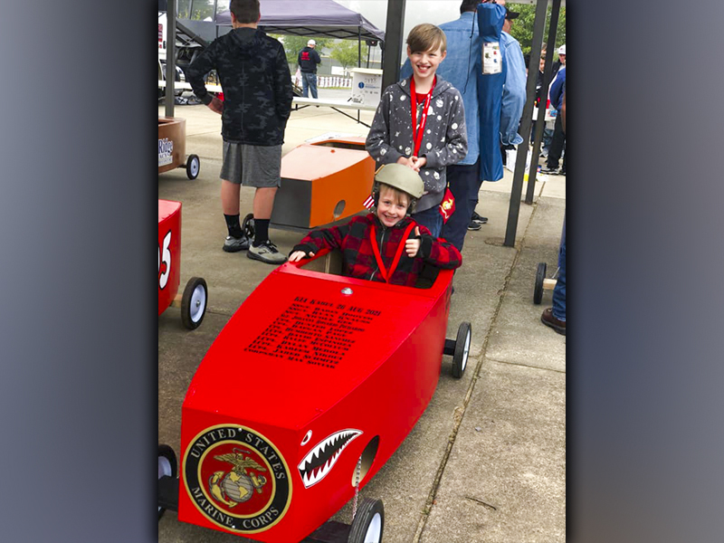 Gideon and Maxwell Scott prepare to race their Lake Blue Ridge Marine Corps League Detachment #1438 car in the Blue Ridge Soap Box Derby Fall Classic. The two each placed within the Bottom 8 Bracket of the race.